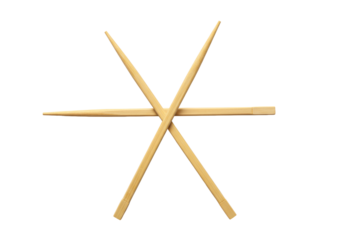 Two identical, polished light bamboo chopsticks, delicately crossed in an 'x' on a transparent matte surface with ample negative space and soft studio lighting. Concept of sustainable choices
