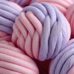 Close-up of soft, chunky yarn balls in pink and lavender