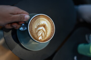 A vintage café scene with a steaming espresso in a white mug on a wooden table, rich with aroma, texture, and timeless style.
