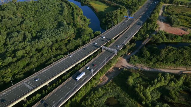 Close aerial video of the M6 motorway on Thelwall Viaduct spanning the River Mersey near Warrington, showcasing the twin carriageways