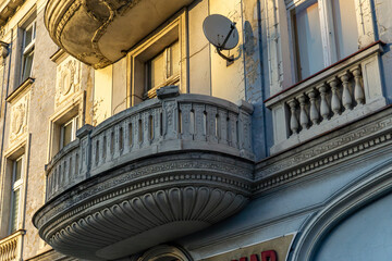Decorated semi-circular tenement balcony with balustrade and stucco, Art Nouveau façade details,...