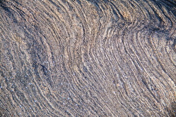 Abstract, natural background. Line pattern on the rough surface of rocks.