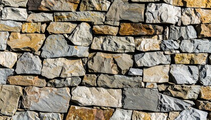 Fototapeta premium Close-up view of a stone wall composed of irregular blocks.