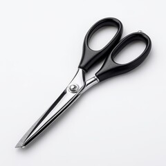 Obraz premium A close-up shot of a shiny pair of scissors lying on a surface, showing the metal blade