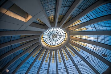 Architectural marvel with stunning glass dome and vibrant sky, inspiring awe and wonder in a modern space