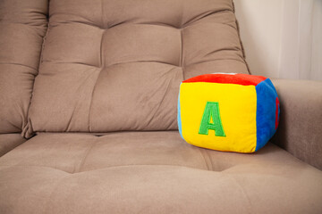 Children's plush dice with the letter A written on them. Letter concept.