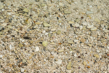 The shore of a pebble beach with clear turquoise water. Likva beach on the island of Brac. Croatia