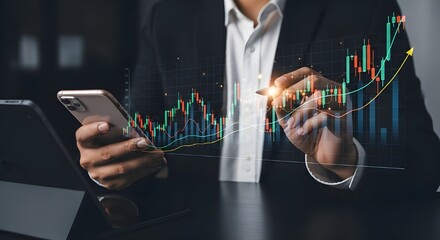 Photorealistic image of a person in a blue collared shirt holding a smartphone and stylus, interacting with a colorful holographic projection of candlestick charts and upward-trending financial graphs