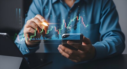 Futuristic digital artwork of hands holding a smartphone and stylus, analyzing holographic stock market data with candlestick and line graphs above a tablet on a dark surface, representing investment 