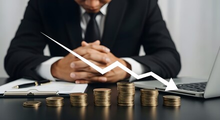 Dramatic image of a professional man showing frustration over declining finances, with a dark desk, descending gold coin stacks, a sharp downward arrow overlay, and blurred background highlighting