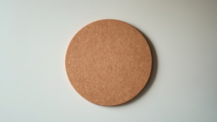 Round cork coaster on light background.