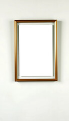 A softly limewashed wall in pale sage green, featuring an ISO A poster mockup in a thin brass frame with a brushed antique finish.