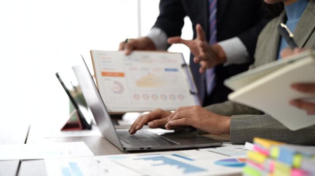 Close-up asia business people meeting plan analysis statistics brainstorm and header of team hold tablet pointing graph chart and employee take note. Finance strategy statistics success concept.