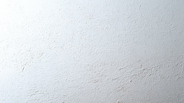 A close-up of a textured white wall with a slightly rough surface,