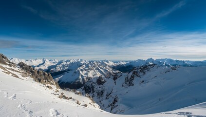 Stunning winter mountain panorama with fresh snow under bright blue sky