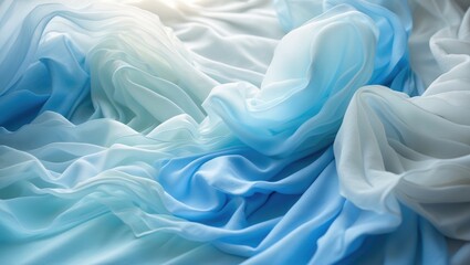 Fototapeta premium Soft, flowing textiles in shades of blue and white with a wrinkled appearance.
