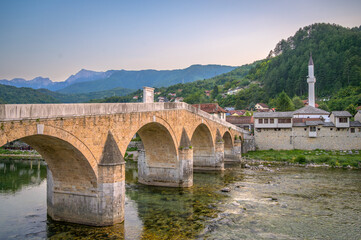Fototapeta premium Historic bridge in Konjic, Bosnia, surrounded by mountains and river views