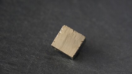 Isolated Pyrite cubic crystal. An iron sulfide mineral also known as fool's gold. Cubic golden shaped natural pattern.