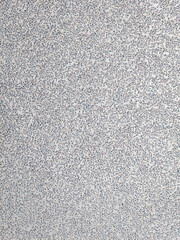 Macro photo of white popcorn ceiling texture with fine speckled pattern