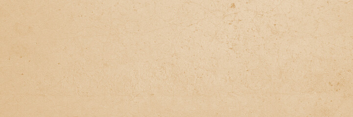 Closeup of a tan or beige colored textured wall, perfect for background images, interior design concepts, or architectural projects.