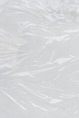 Crumpled plastic wrap with reflective surface. Great for design projects needing a textured, modern look with a sleek aesthetic.