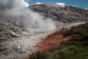 Geothermal terrain with red and white mineral deposits at Le Biancane, Tuscany