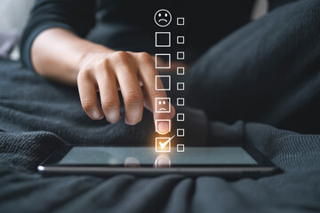 Submitting Low Feedback on a Digital Device A Hand Tapping a Checkmark Next to a Negative Emotion Icon on a Customer Survey Application