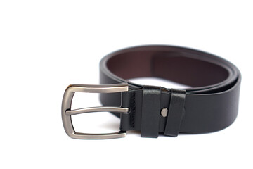 Close-up of a stylish black leather men’s belt with metallic buckle on white background. Fashion accessory for formal and casual wear, symbol of style, durability, and essential men’s wardrobe item.  