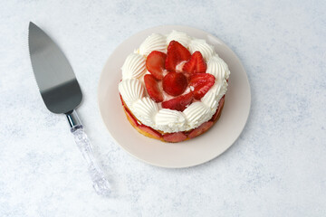 Strawberry cream cake on white plate dessert concept for celebration table or sweet food promotion