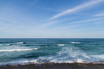 tranquil seascape with clouds and waves on the beach