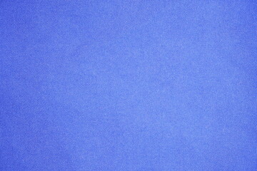 Detailed texture of a vibrant royal blue fabric background showcasing fine weave pattern
