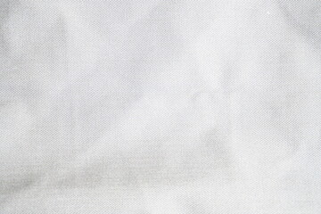 Close-up of a white fabric texture displaying fine woven patterns