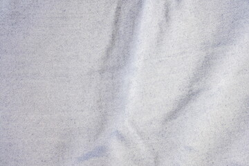 Fototapeta premium Close-up of white fabric texture showcasing detailed threaded weaving pattern with natural folds and shadows