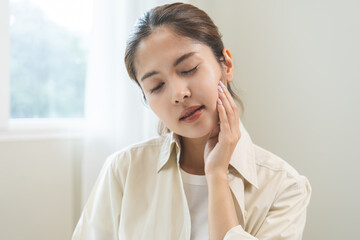 Jaw pain, health care concept. Teeth pain and dentistry asian young woman, girl suffering touching her cheek. Female feeling painful toothache. Unhappy feel bad, diseases in oral, ache nerve and molar