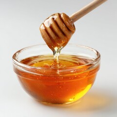 Honey pot and dipper on white background.