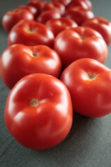 red tomatoes on the table surface
