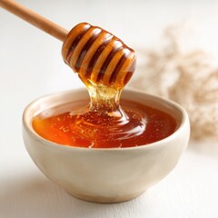 Honey pot and dipper on white background.