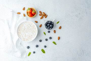 Oatmeal porridge with blueberries, strawberries, almonds and milk