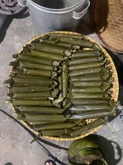 Lontong is a traditional Indonesian dish made from rice that is boiled and compressed in banana leaves, then cut into small cylindrical or round pieces. The texture is firm yet soft, and it has a mild