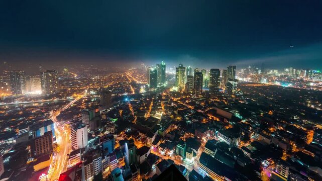 Aerial view of the illuminated cityscape at night in manila, philippines