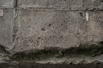 Cracked concrete with green moss for concepts of erosion, decay and natural textures