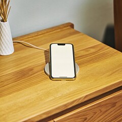 Digital communication equipment including laptops, tablets, and phones sits on a wooden office desk