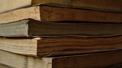 Stacked Antique Books CloseUp of Aged Pages and Covers in Warm Muted Tones.