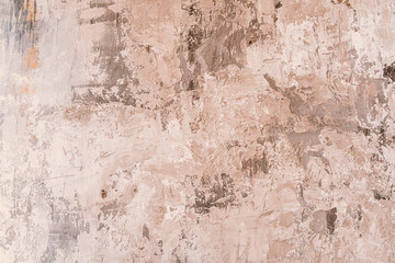 Abstract texture of weathered plaster on a wall showcasing natural tones
