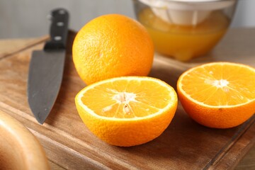 Making juice. Fresh oranges, juicer and knife on table, closeup