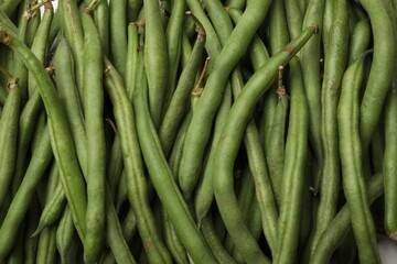 Fresh pea pods as background, top view