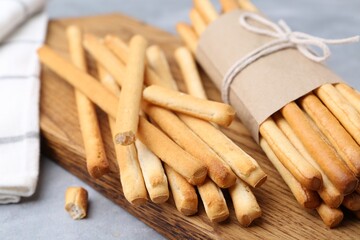 Delicious grissini sticks on grey table, closeup