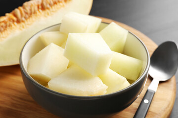 Cut ripe melon in bowl on table, closeup