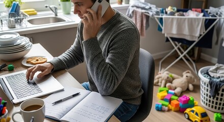 Busy father multitasking, working remotely on a laptop and phone call amidst domestic chaos.