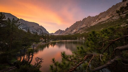 Fototapeta premium Majestic mountain lake reflects a vibrant sunset sky with fiery orange and purple hues